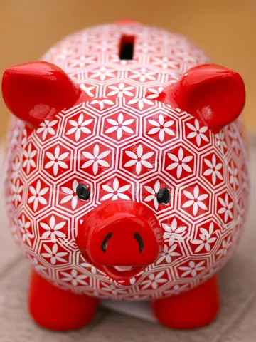 Red with white floral painted piggy bank.