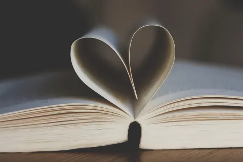 Open book with heart shaped pages.
