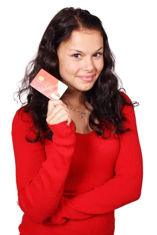 Teenage girl wearing red shirt and holding debit card
