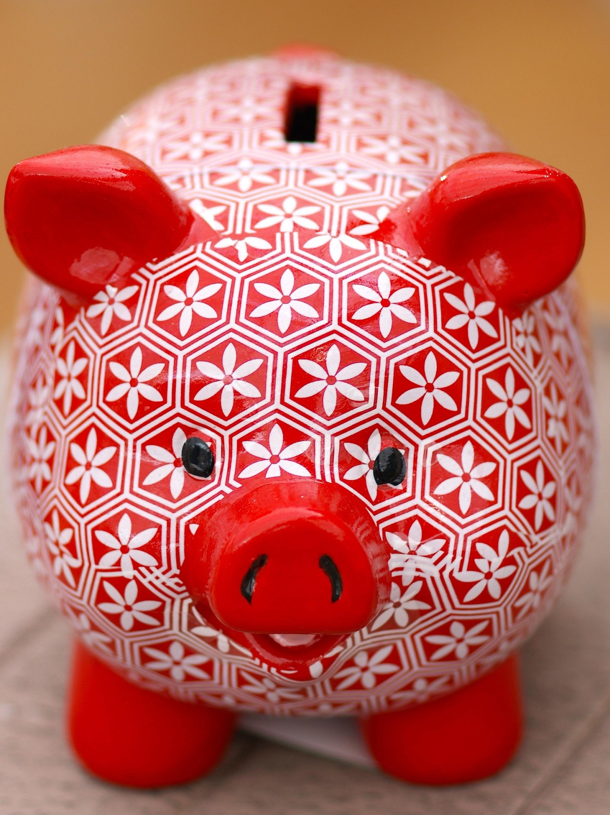 Red with white floral painted piggy bank.